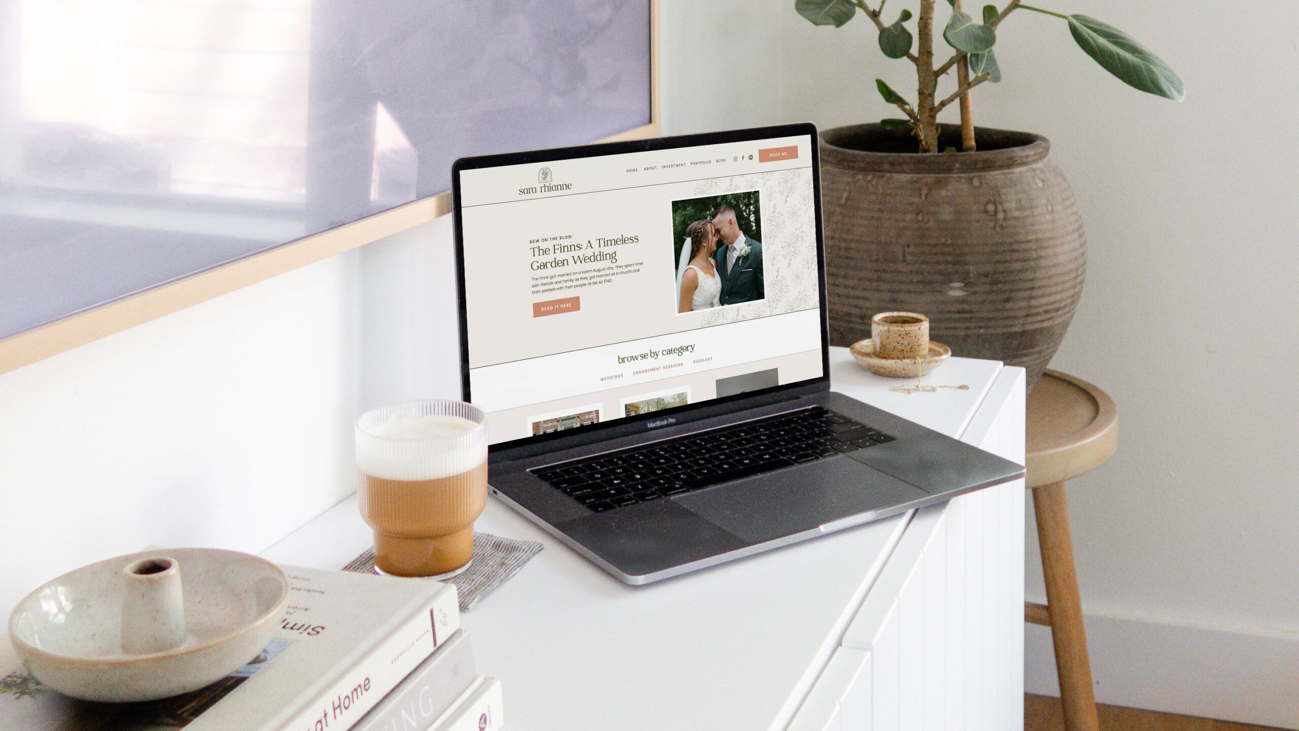 Laptop sitting on dresser next to coffee cup