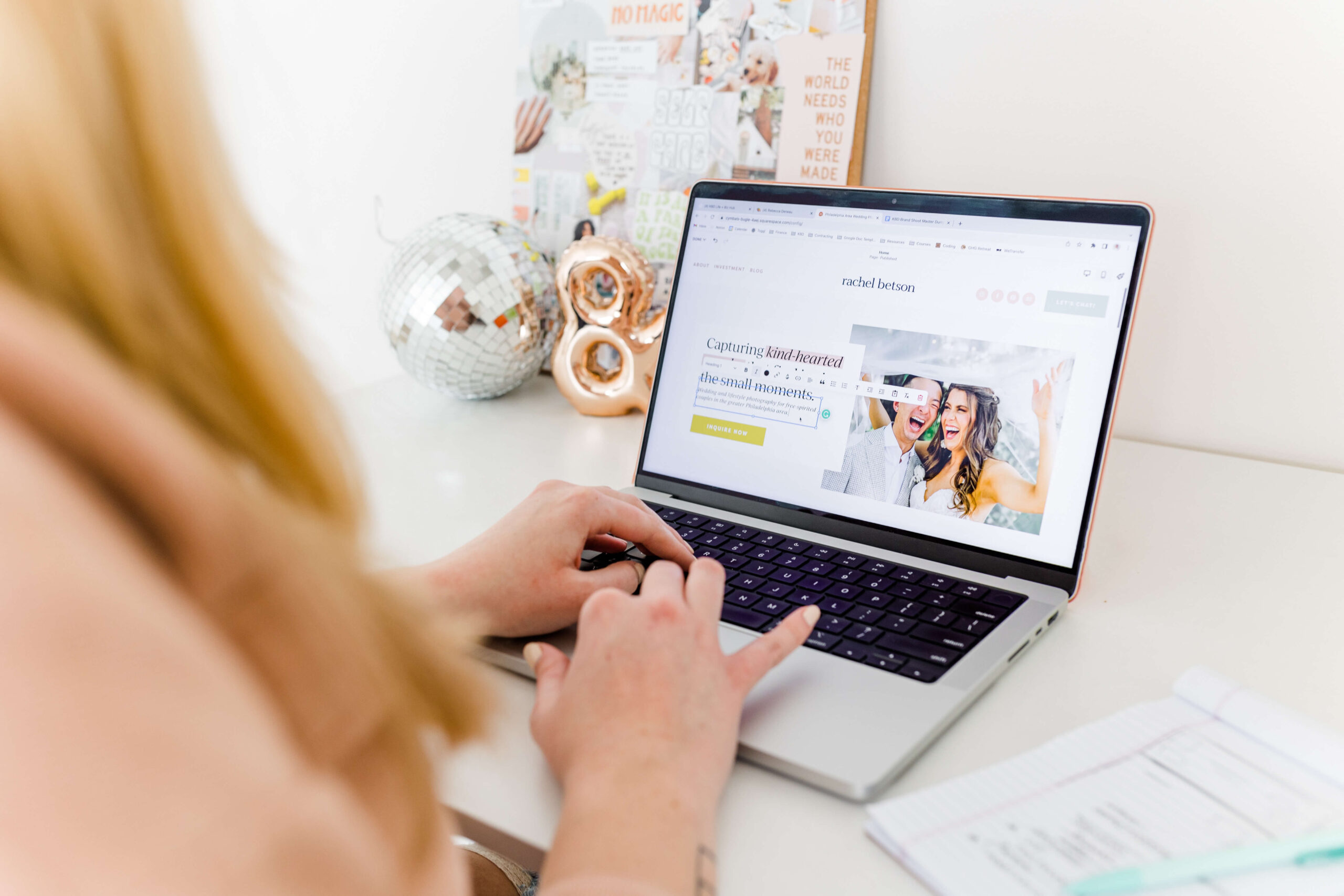 woman with blonde hair typing on computer designing website for female photographer