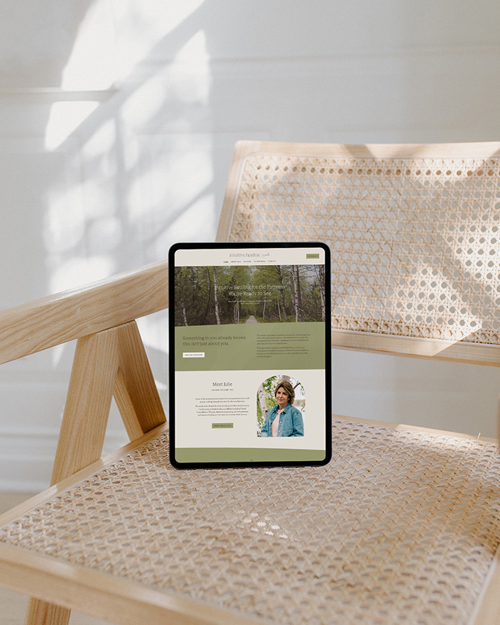 ipad on wicker cane chair in sunlight showing website design for Intuitive Healing by Julie