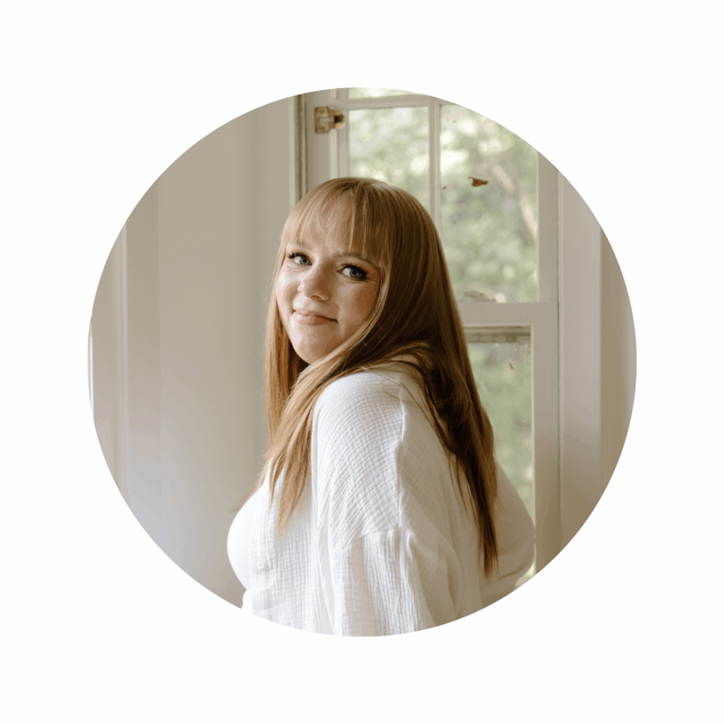 Woman with blonde hair wearing white blouse smiling at camera